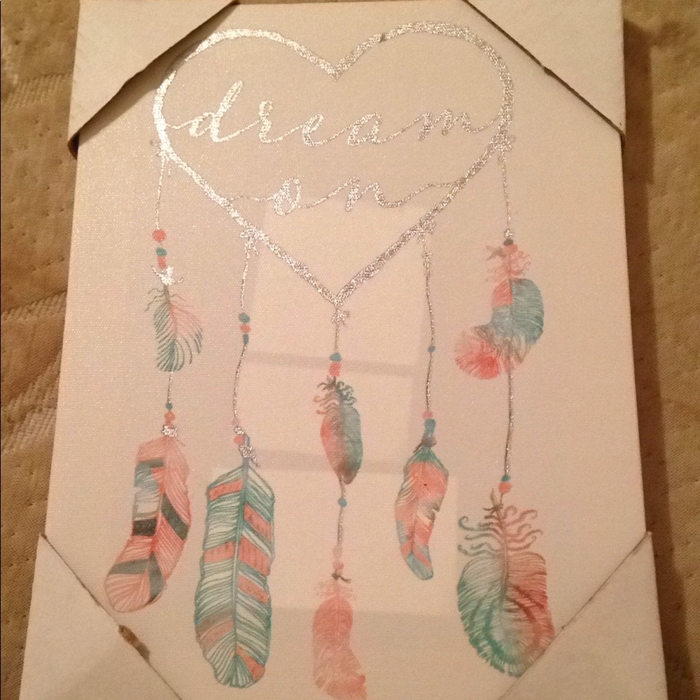 A canvas with silver pink and turquoise writing